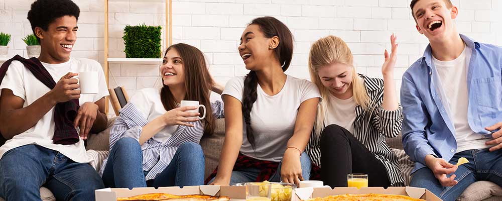 happy-teens-eating-pizza-at-party happy-teens-eating-pizza-at-party